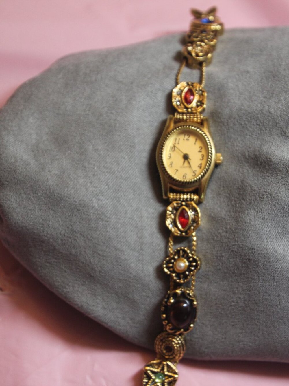Vintage gold tone watch with charms. Avon. See description below.